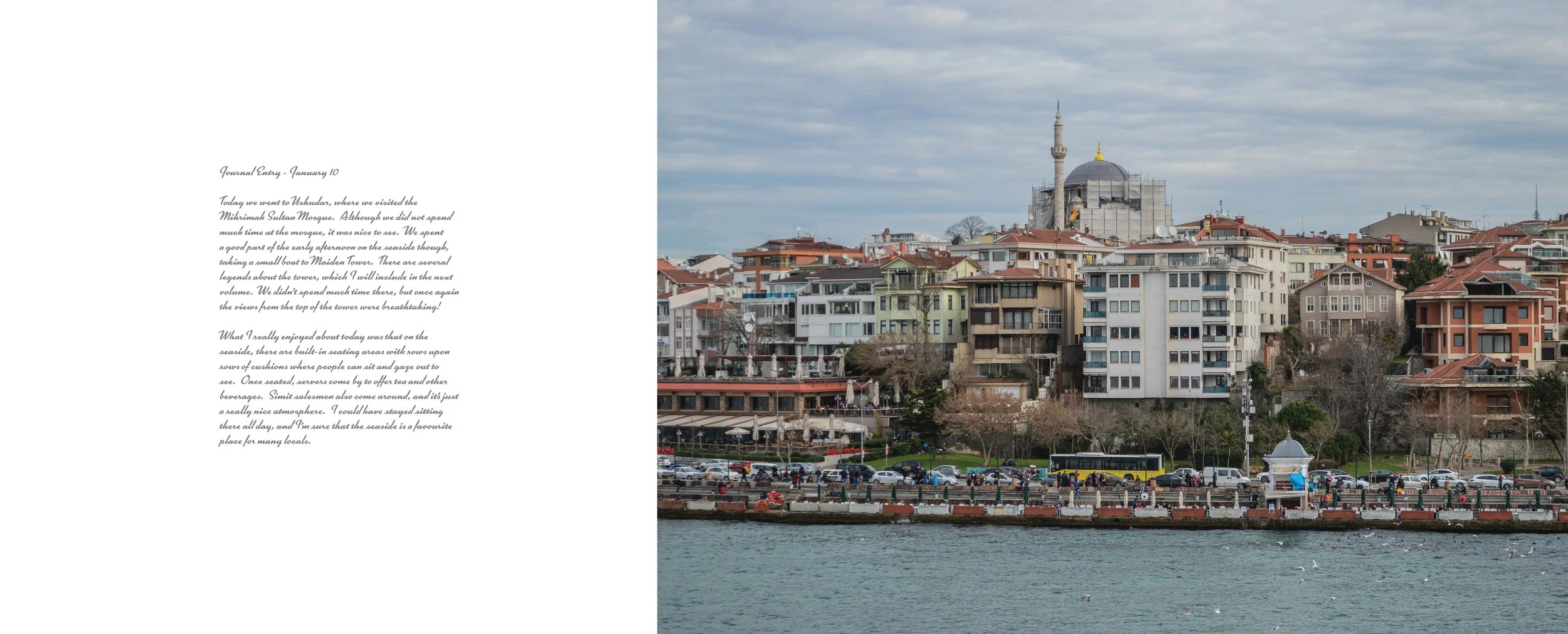 A cityscape featuring colorful apartment buildings along the waterfront, with a mosque with a prominent domed roof and minaret under construction in the background. The waterfront area shows a promenade with people, trees, and parked cars.