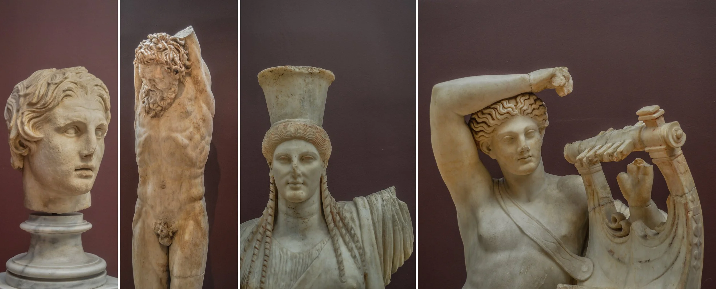 Collection of ancient Greek marble sculptures, including busts and full figures, displayed against a dark background.