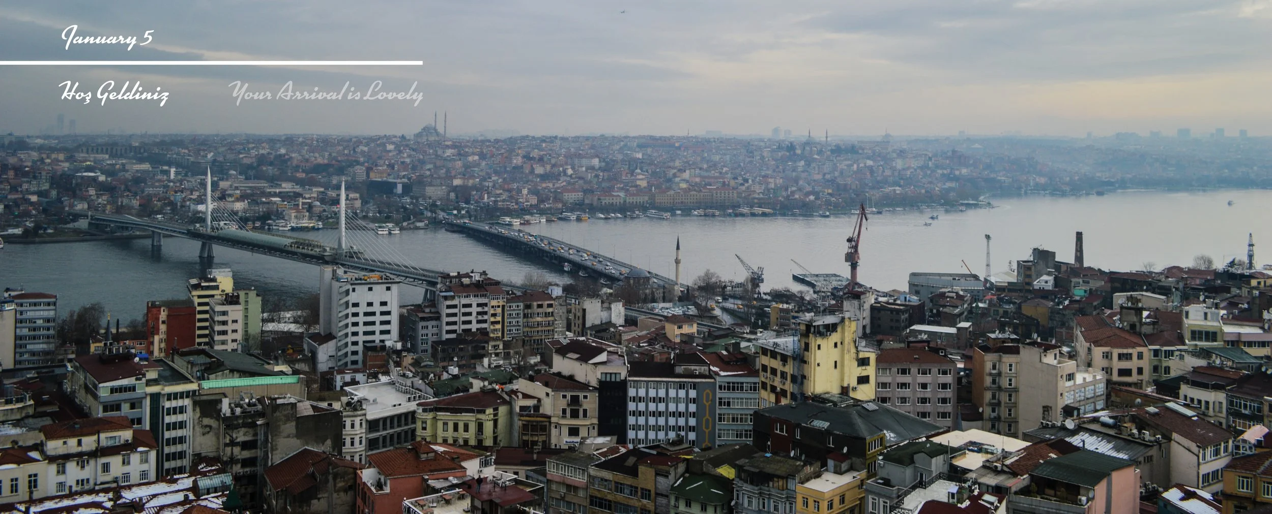 Cityscape with a river, bridge, and numerous buildings on an overcast day.