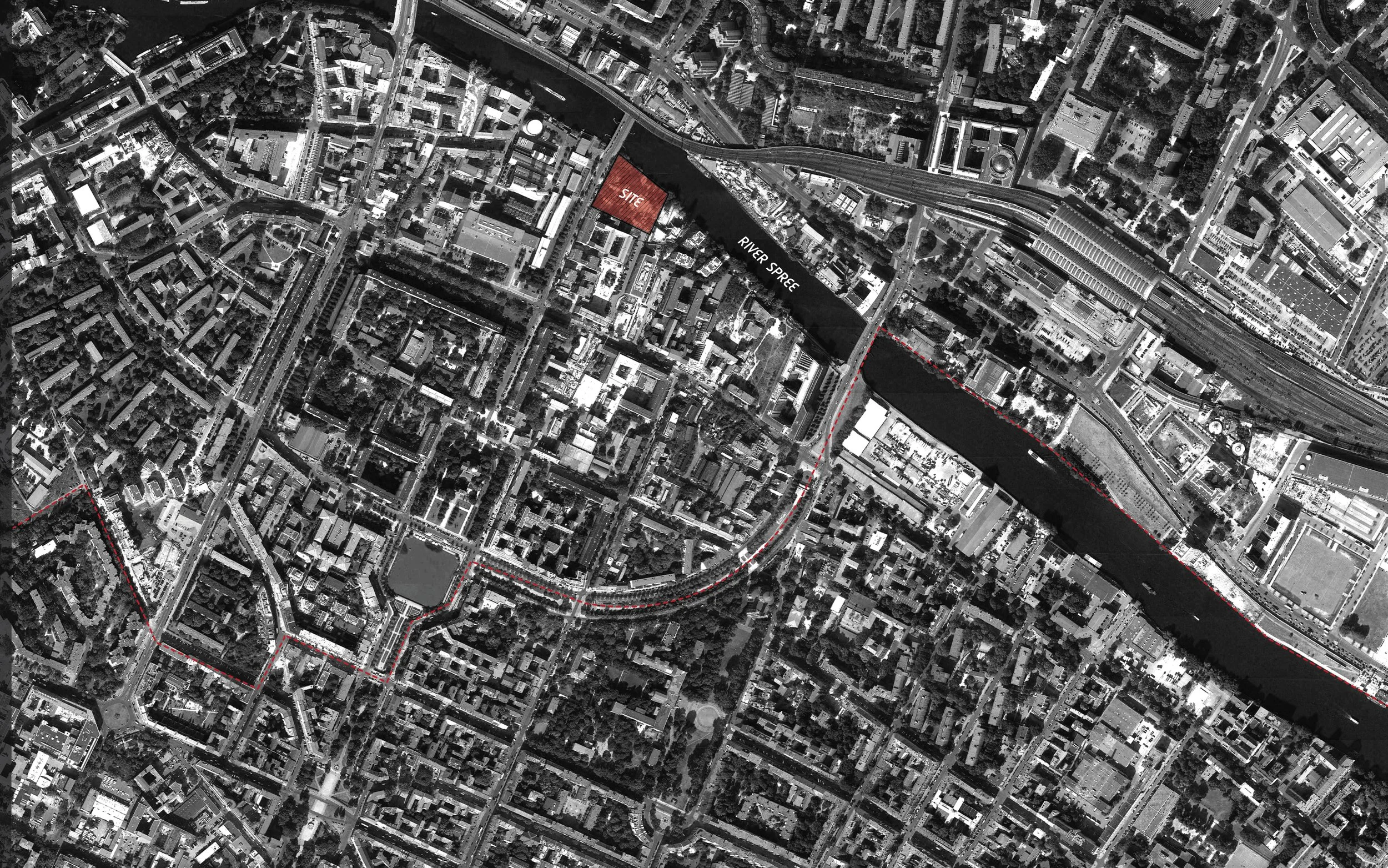 Black and white aerial view of a city with a river running through it, marked with a red shaded area labeled 'SITE' and red dashed boundary lines.