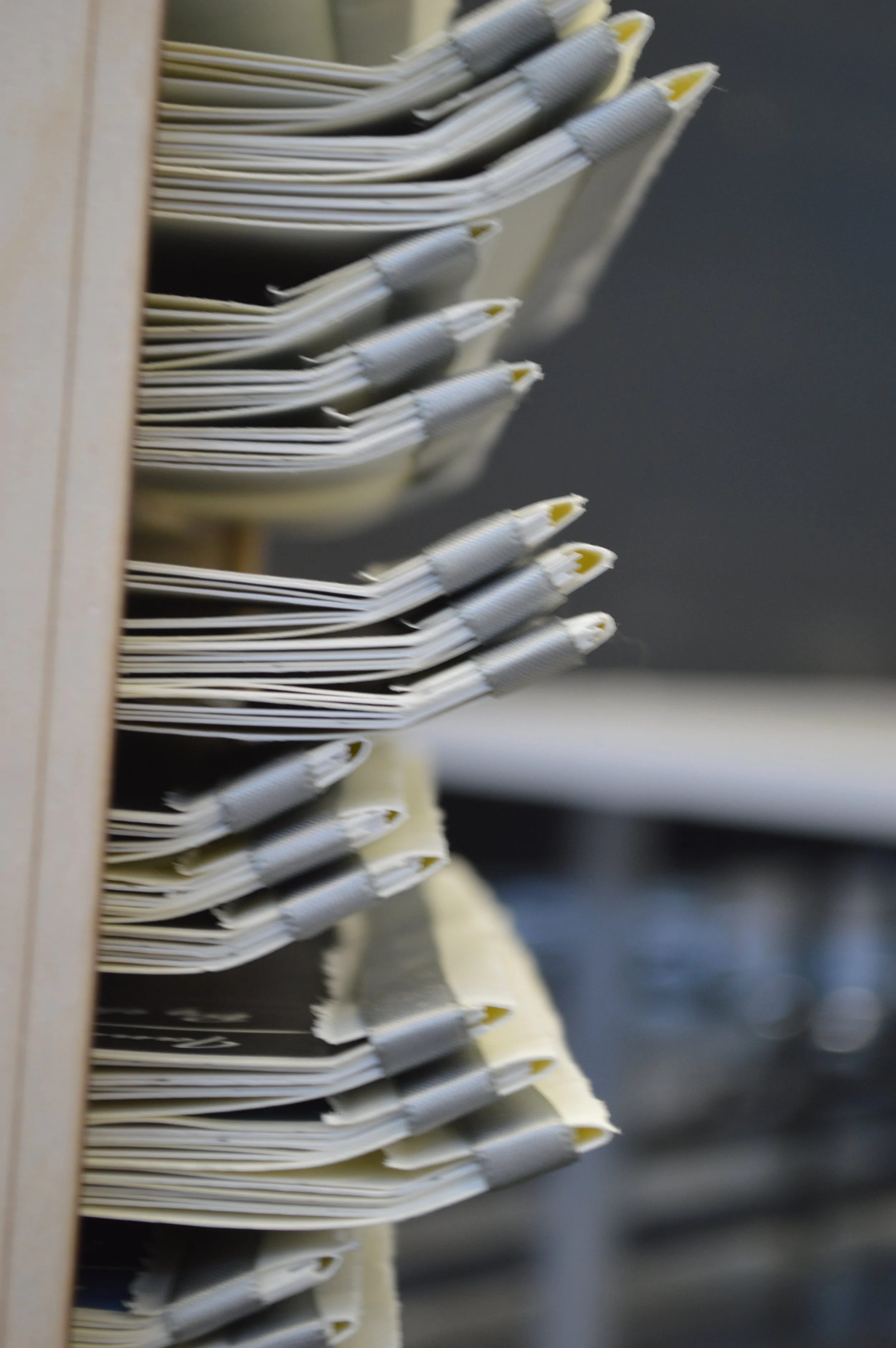 Close-up of a file drawer with dividers and hanging folders filled with papers.