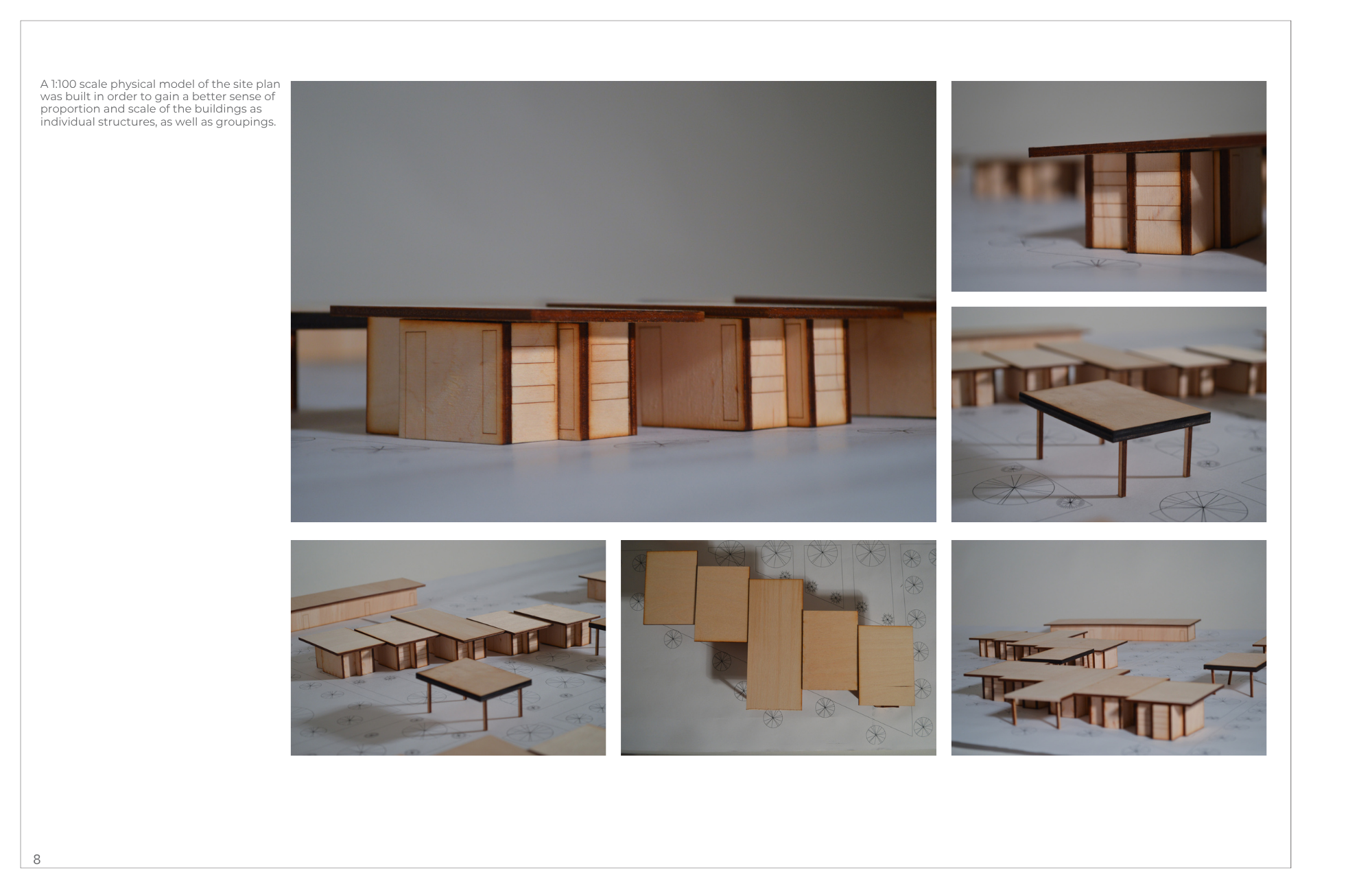 A detailed architectural model of a building with multiple sections, made of light and dark wood, placed on a blueprint with sketches of layout plans and measurements.