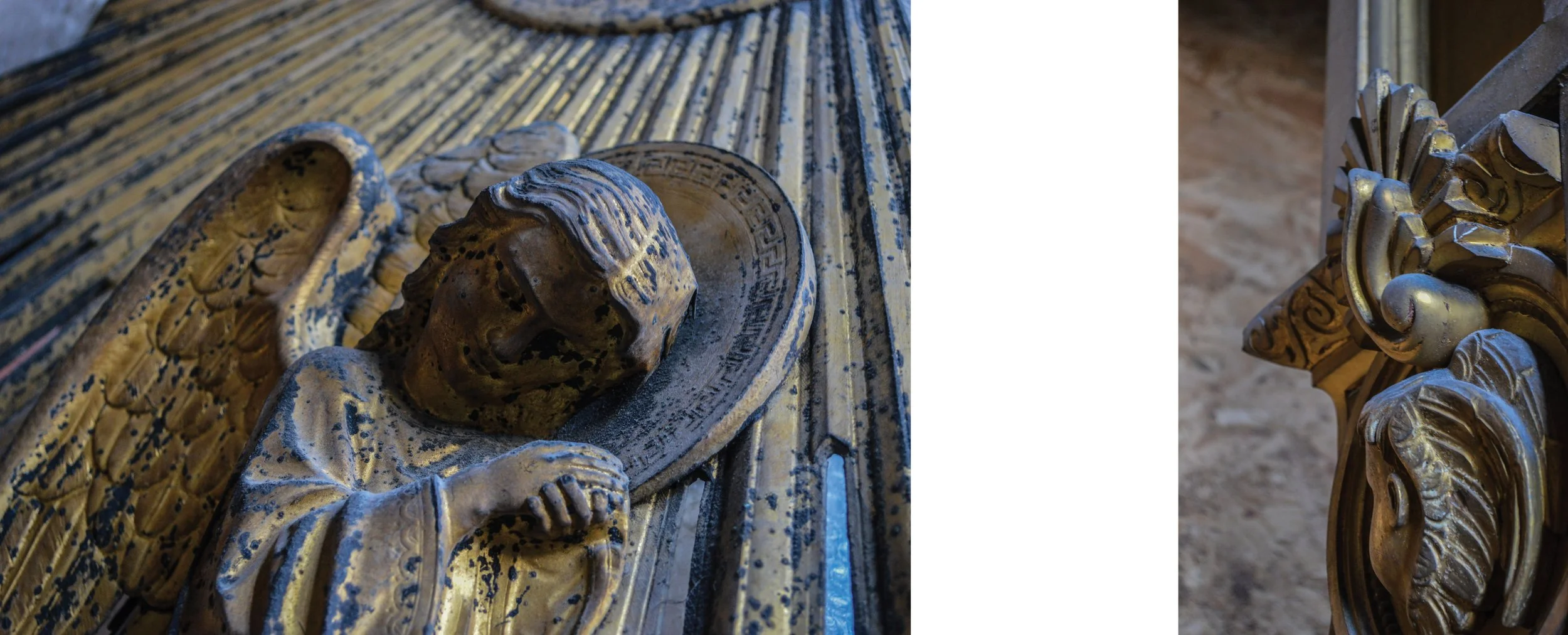 Close-up of a wooden sculpture of a crowned figure with a halo, lying on a decorated surface, with ornate gold-colored architectural details nearby.