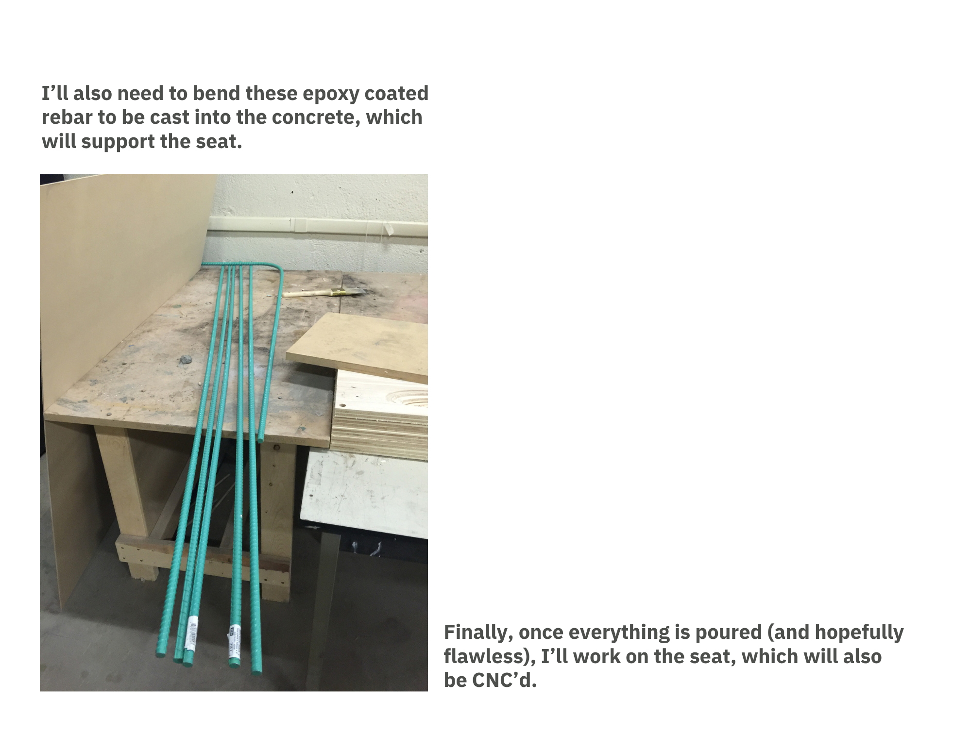 Close-up of a construction site with blue epoxy-coated rebar laid out on a wooden form. The background shows a white wall and some construction tools.