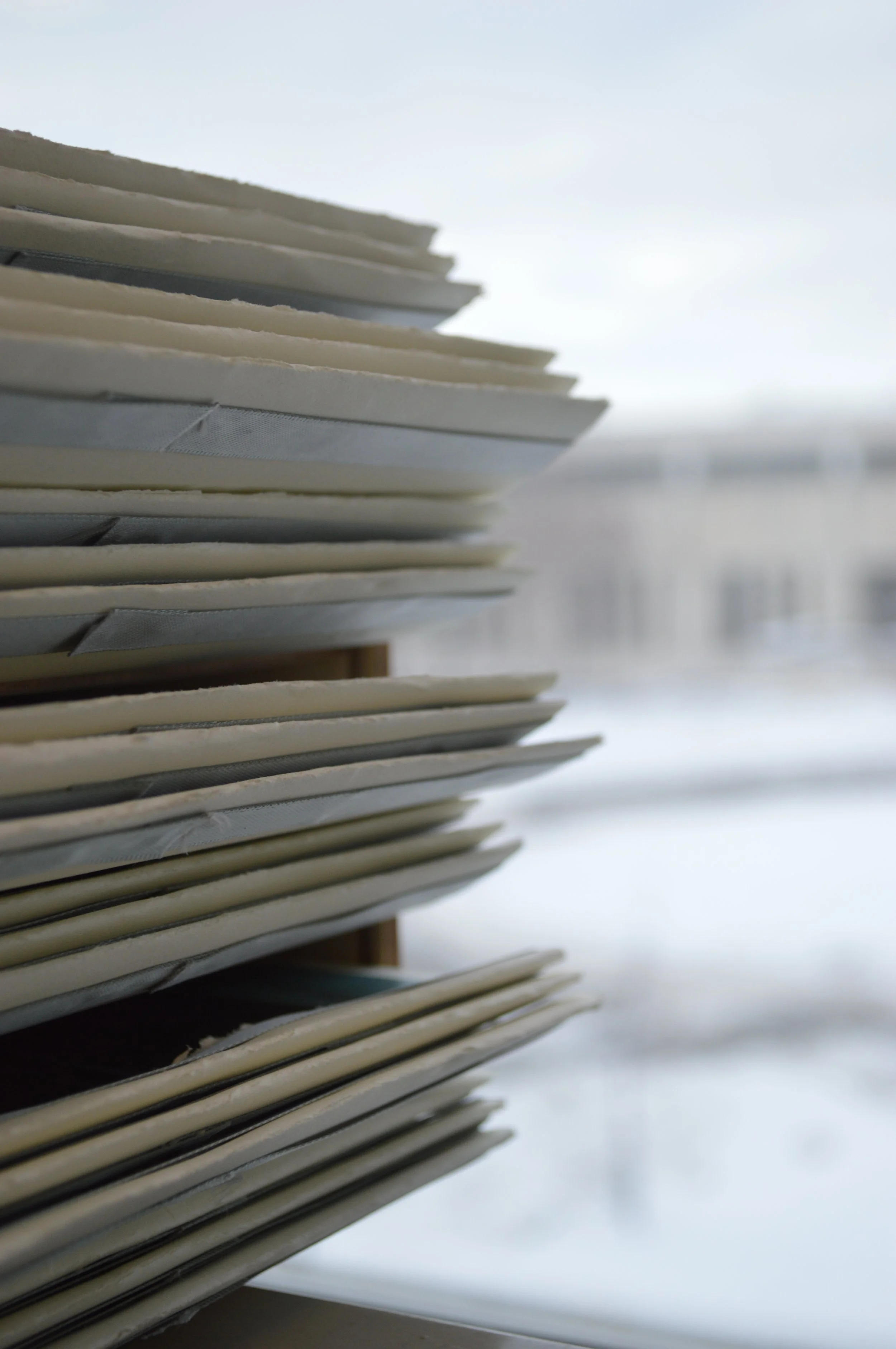 Close-up of a stack of hanging file folders in an office setting.
