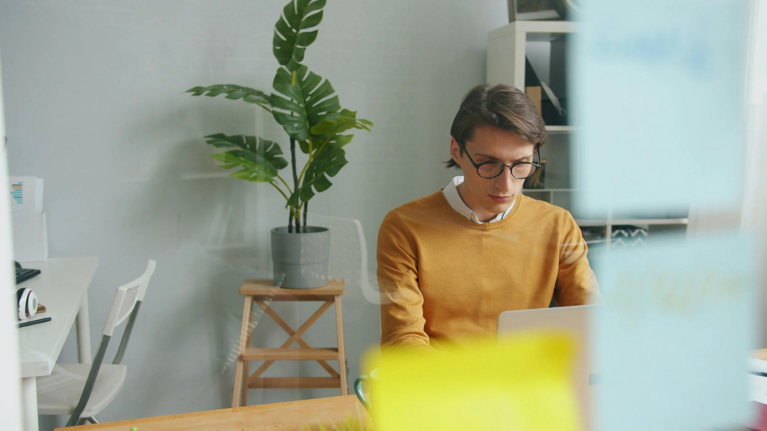 Professional sitting at a desk after finishing work, looking thoughtful despite crossing items off a to-do list, representing the feeling of never doing enough.