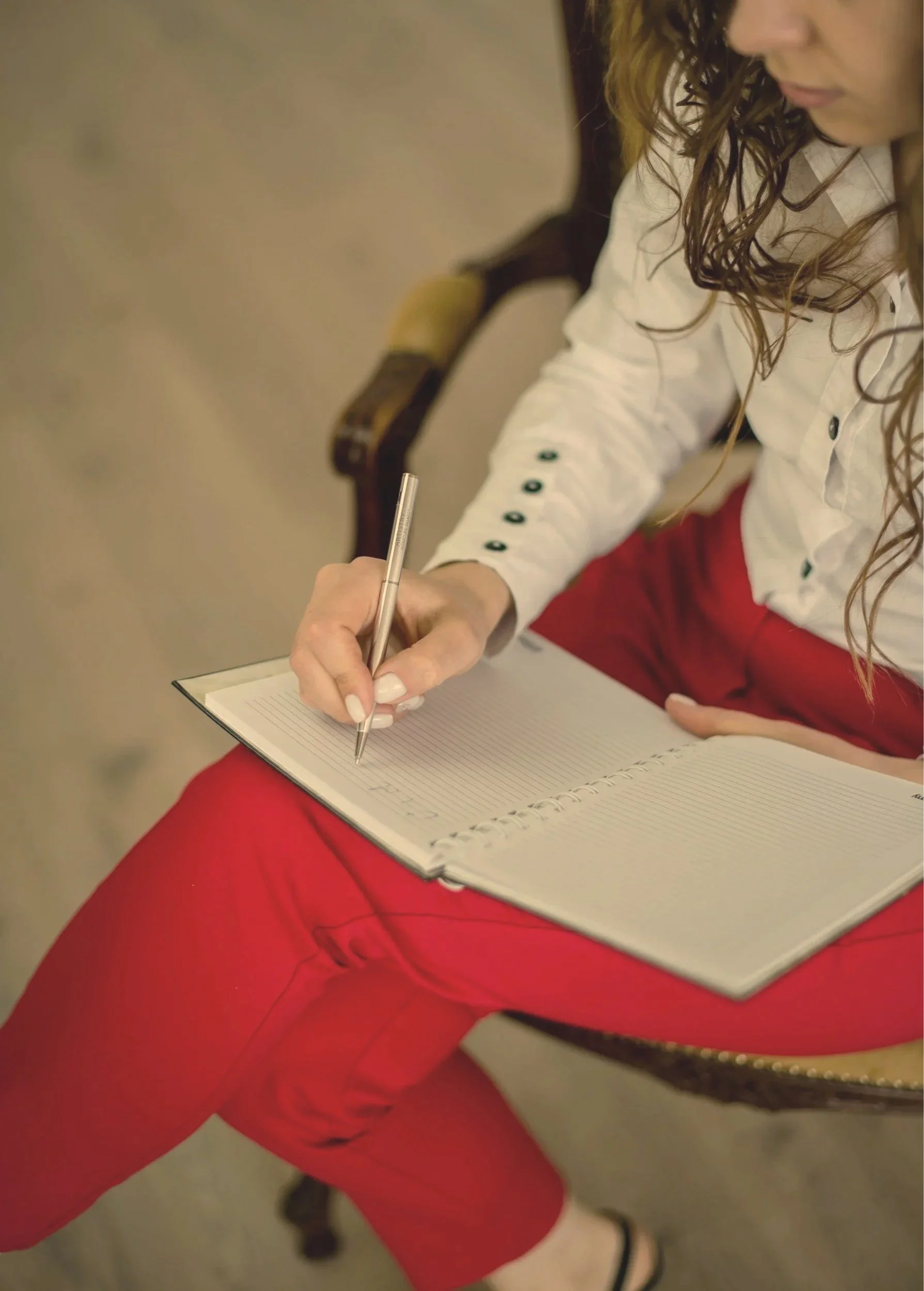 Female therapist in NY NJ taking notes on perfectionism, anxiety, relationship issues.