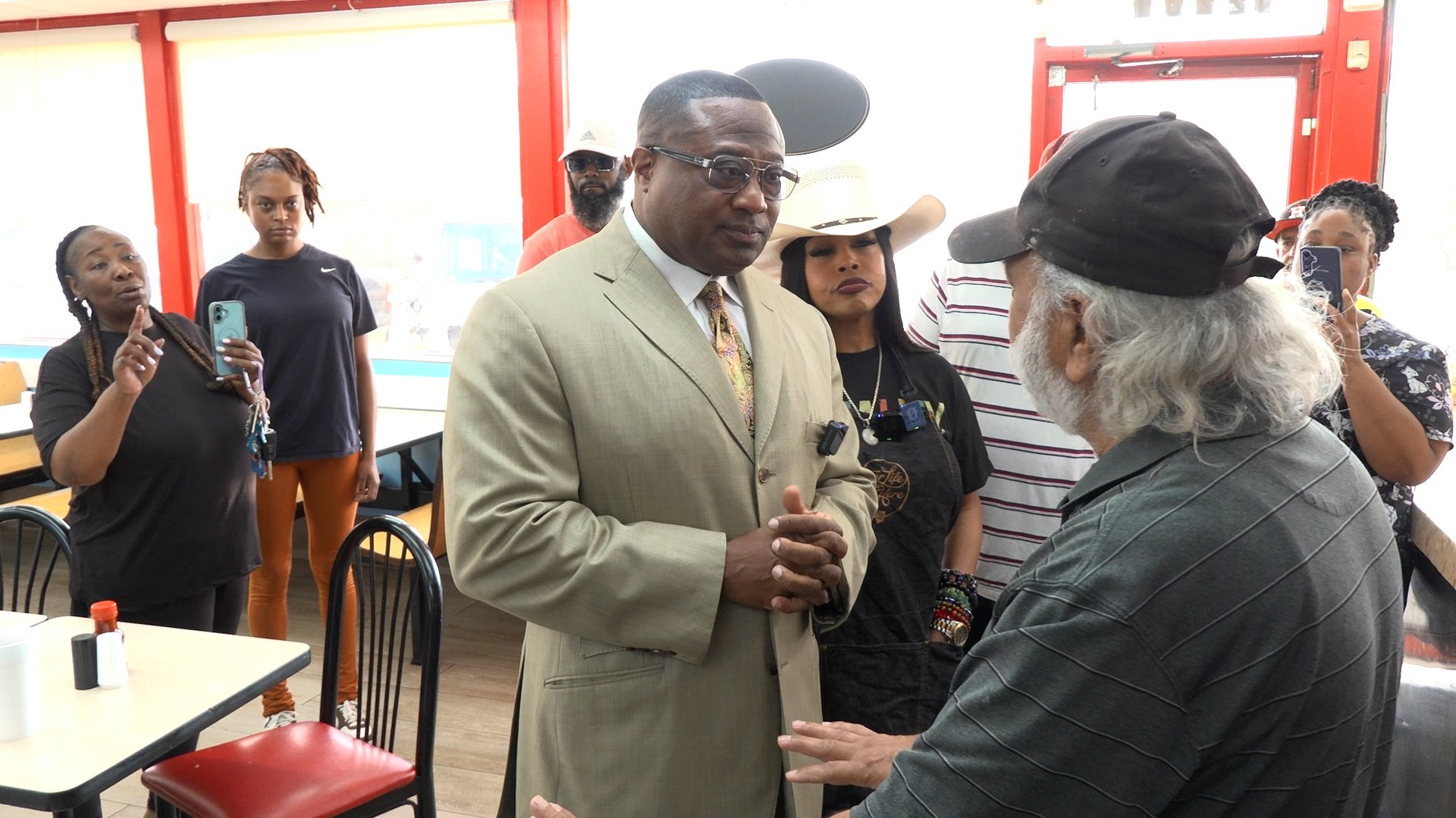 Activists confront Hartz Chicken owner after employee allegedly used racial slur toward customer