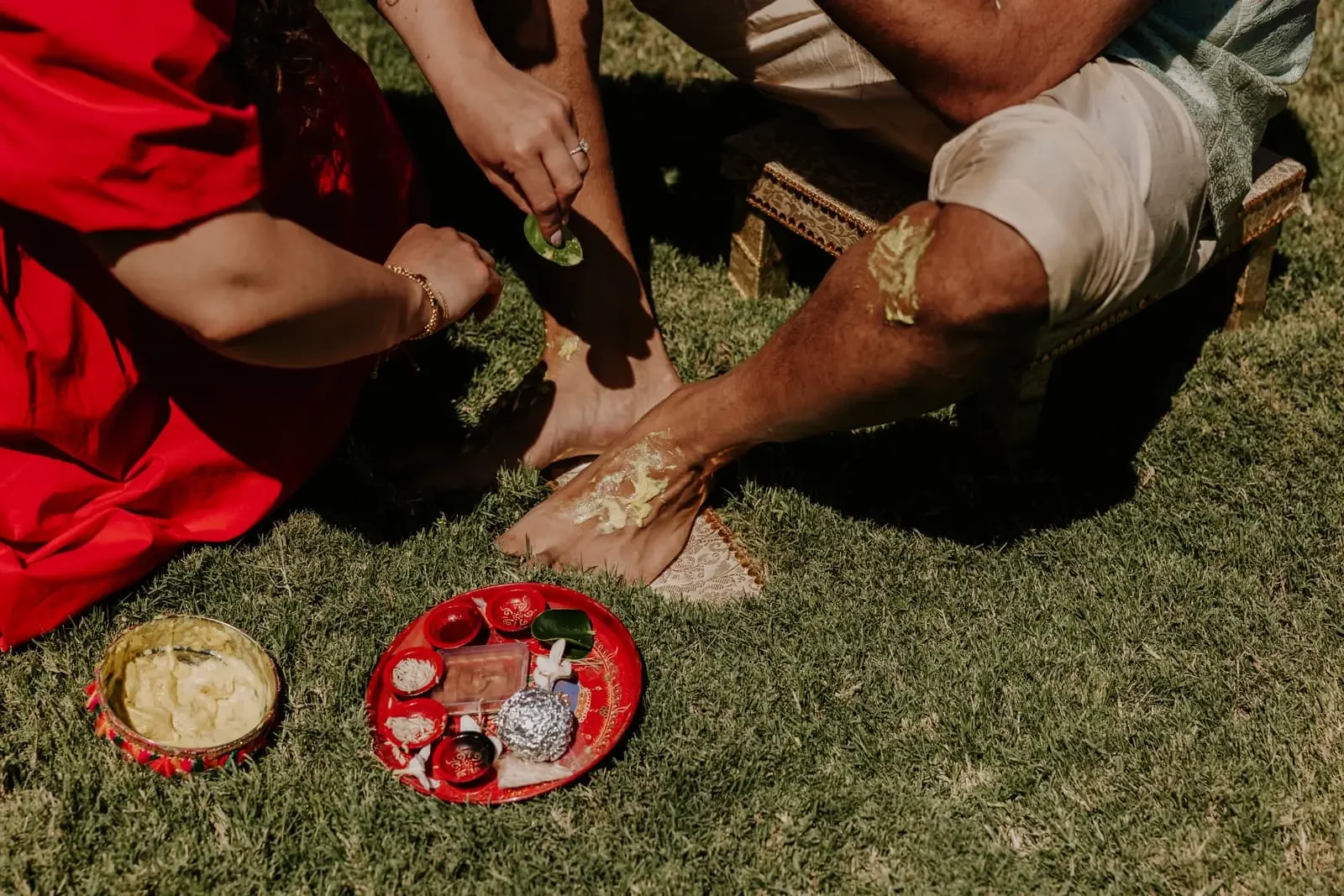 Traditional Haldi ceremony at a luxury Hindu destination wedding in Sicily, Italy, featuring the bride and groom participating in the sacred turmeric ritual before the wedding ceremony.