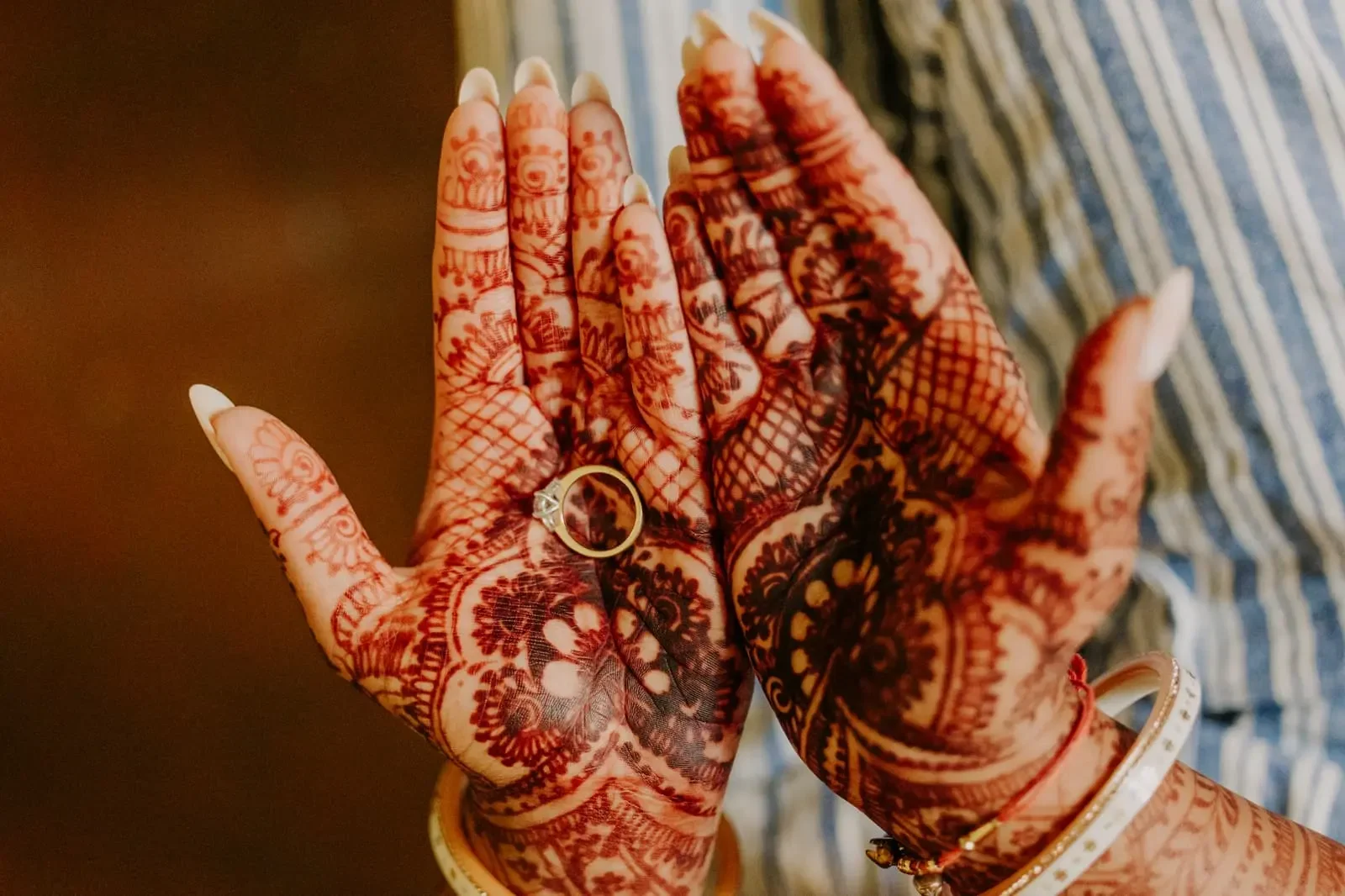 Traditional bridal mehndi with wedding rings during a luxury Hindu destination wedding in Sicily, Italy, showcasing intricate henna artistry and Indian wedding traditions.
