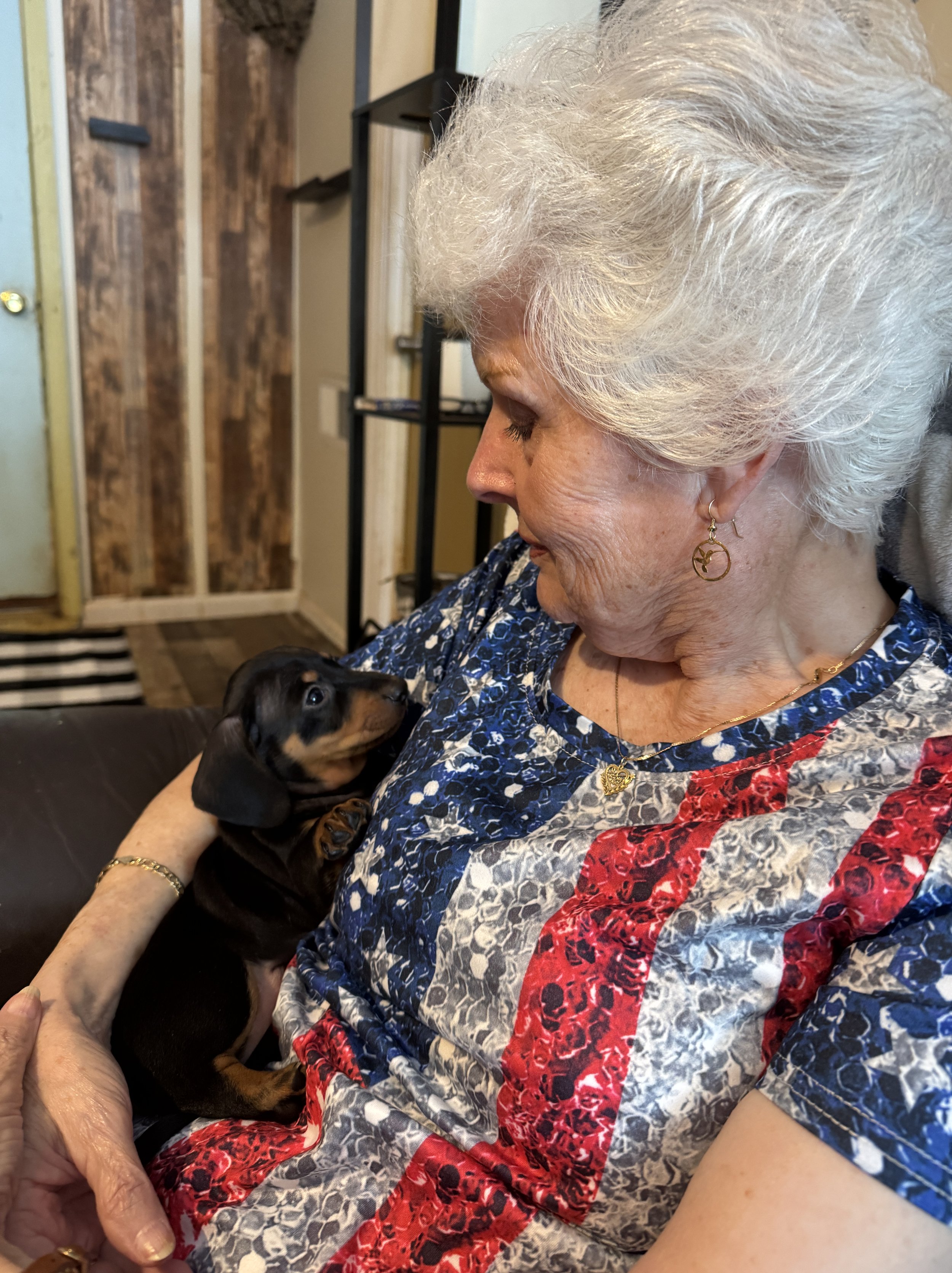 Lady holding her new puppy after waiting 3 years to purchase