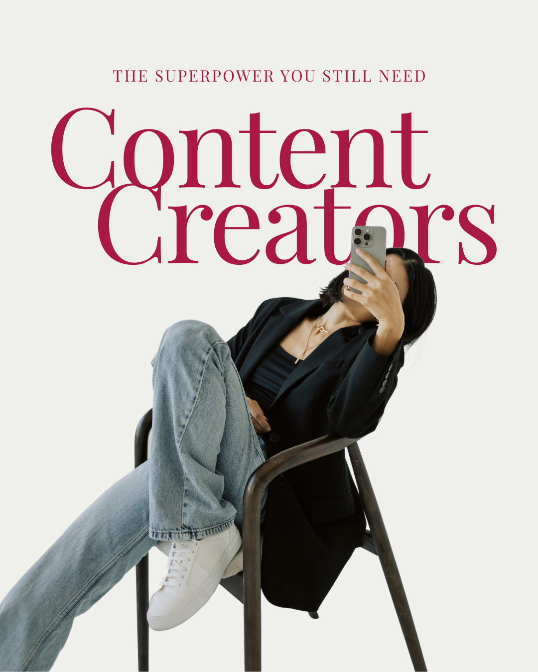A woman sitting in a chair, wearing a black blazer and jeans, taking a selfie with a smartphone. Text on the image reads "The Superpower You Still Need: Content Creators."