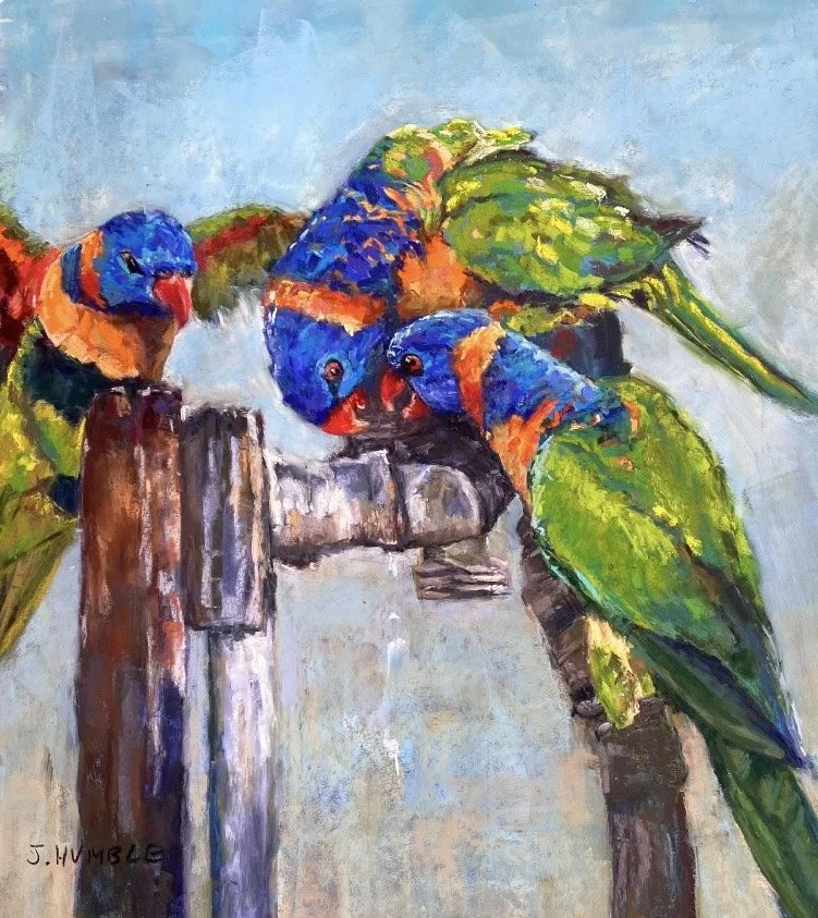 Colorful painting of three parrots with vibrant blue, green, orange, and yellow feathers, perched on wooden posts.