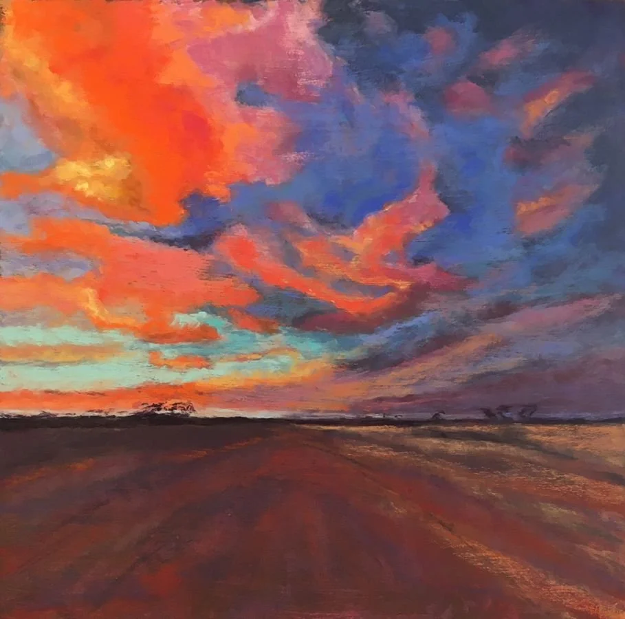 A vibrant oil painting of a sunset sky with pink, orange, purple, and blue clouds above a flat, open landscape with a dirt road or field.