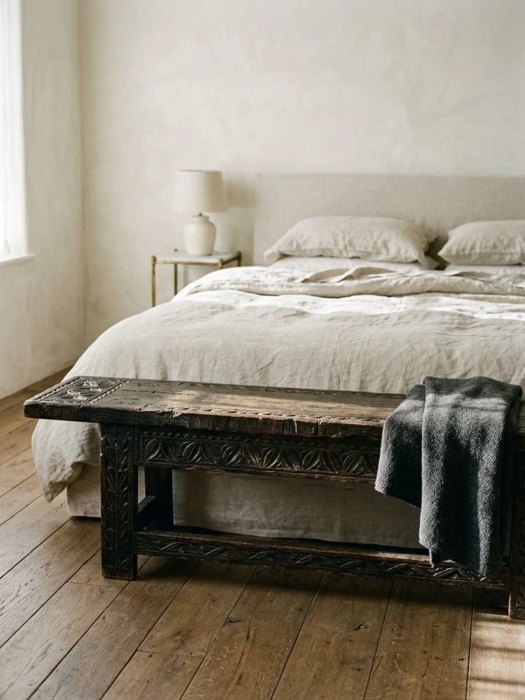 bed with a bench in front of it