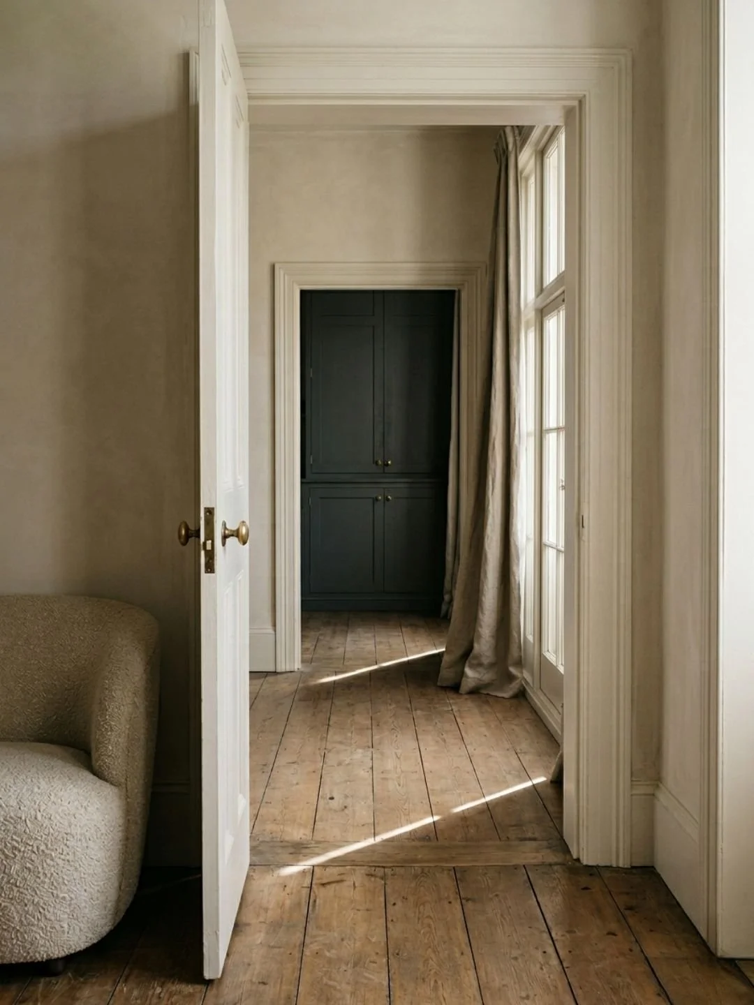 Living room with open door showing flow in between rooms