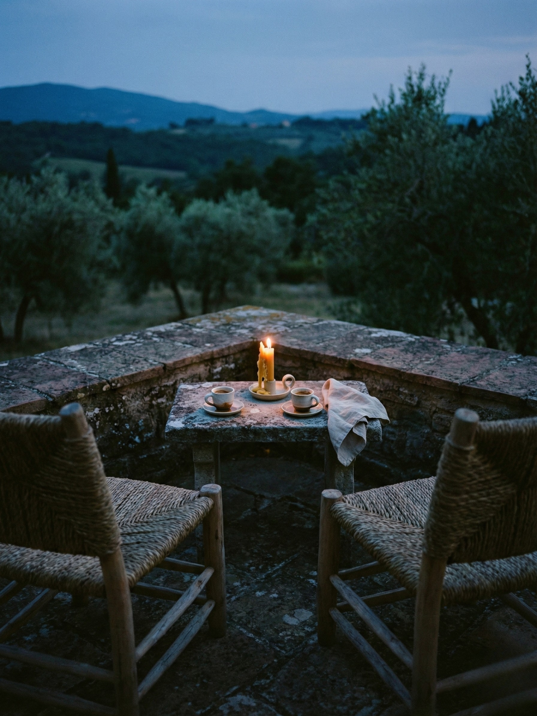 Outdoor seating area, table with two espresso and a candle