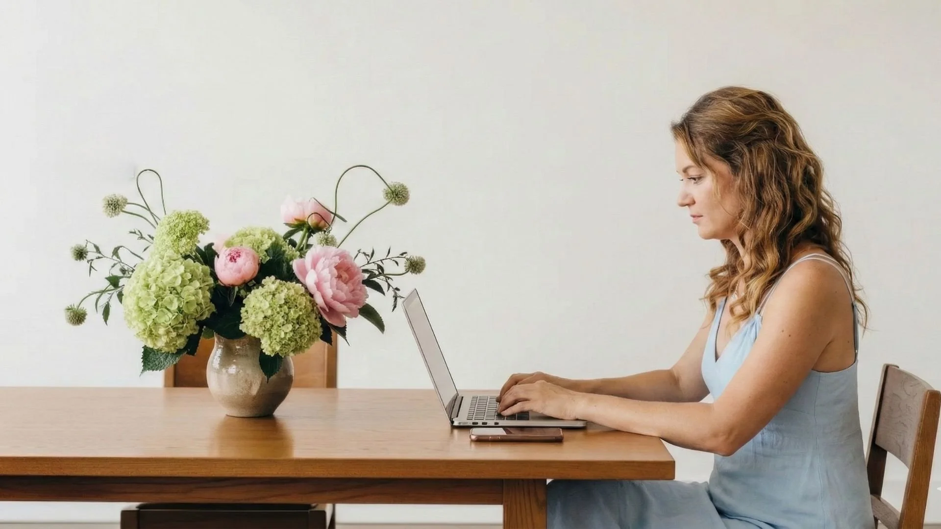 Franzi Ferrier sitting on a desk with her laptop