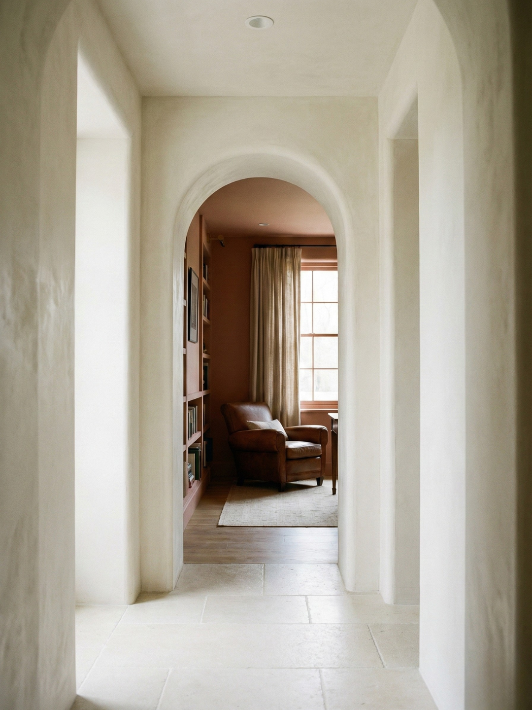 View from white hallway into a study room