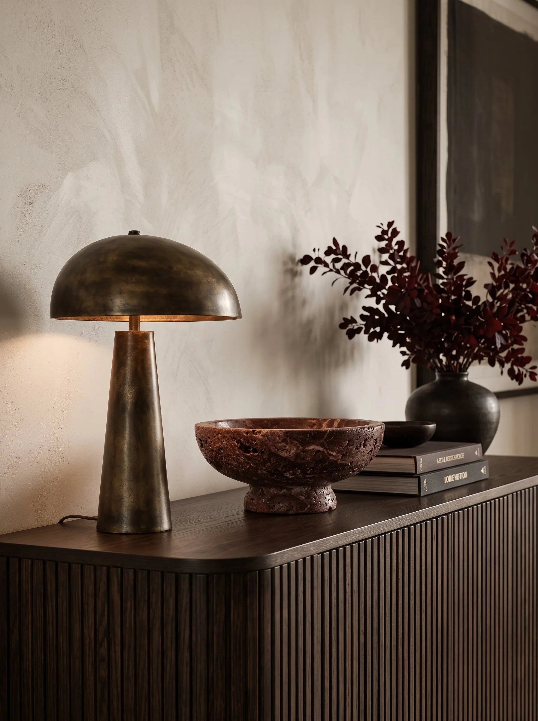 Walnut sideboard styled with brass and burgundy decor