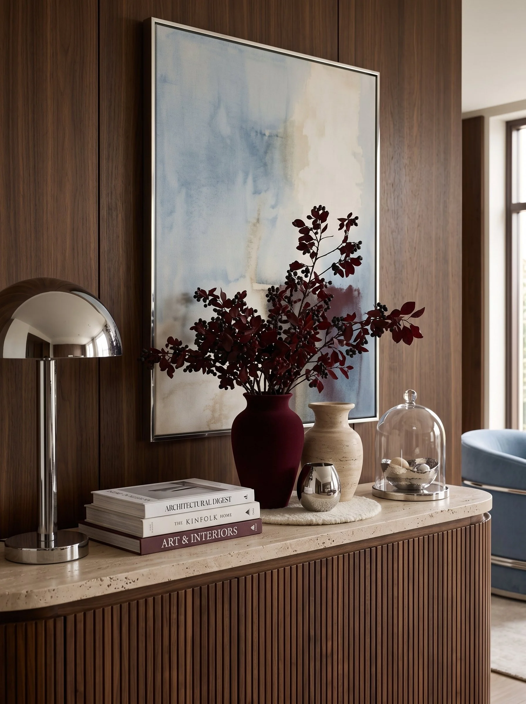 consolte table with burgundy vase, powder blue wall art and chrome mushroom lamp
