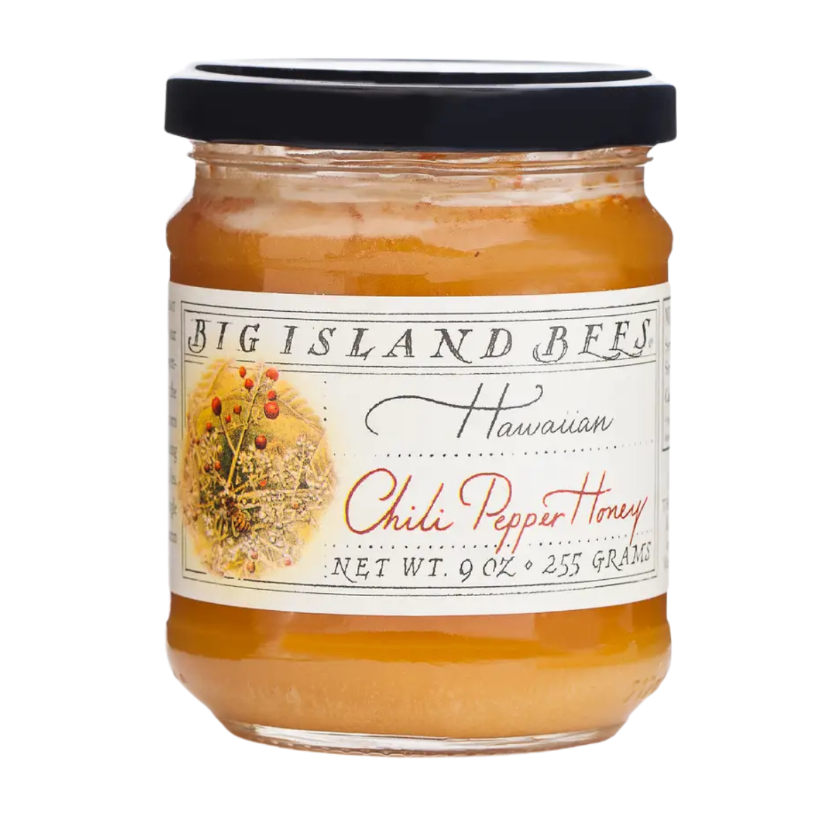A jar of Big Island Bees Hawaiian Chili Pepper Honey with a black lid and white label featuring a colorful illustration of plants and chili peppers.