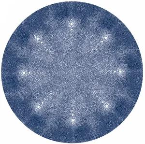Close-up of a circular, sparkly blue design with bright points forming a starburst pattern.
