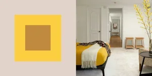 Colorful geometric wall art with a yellow border and brown square, alongside a bedroom interior with a bed, yellow throw, chairs, and a decorative plant.