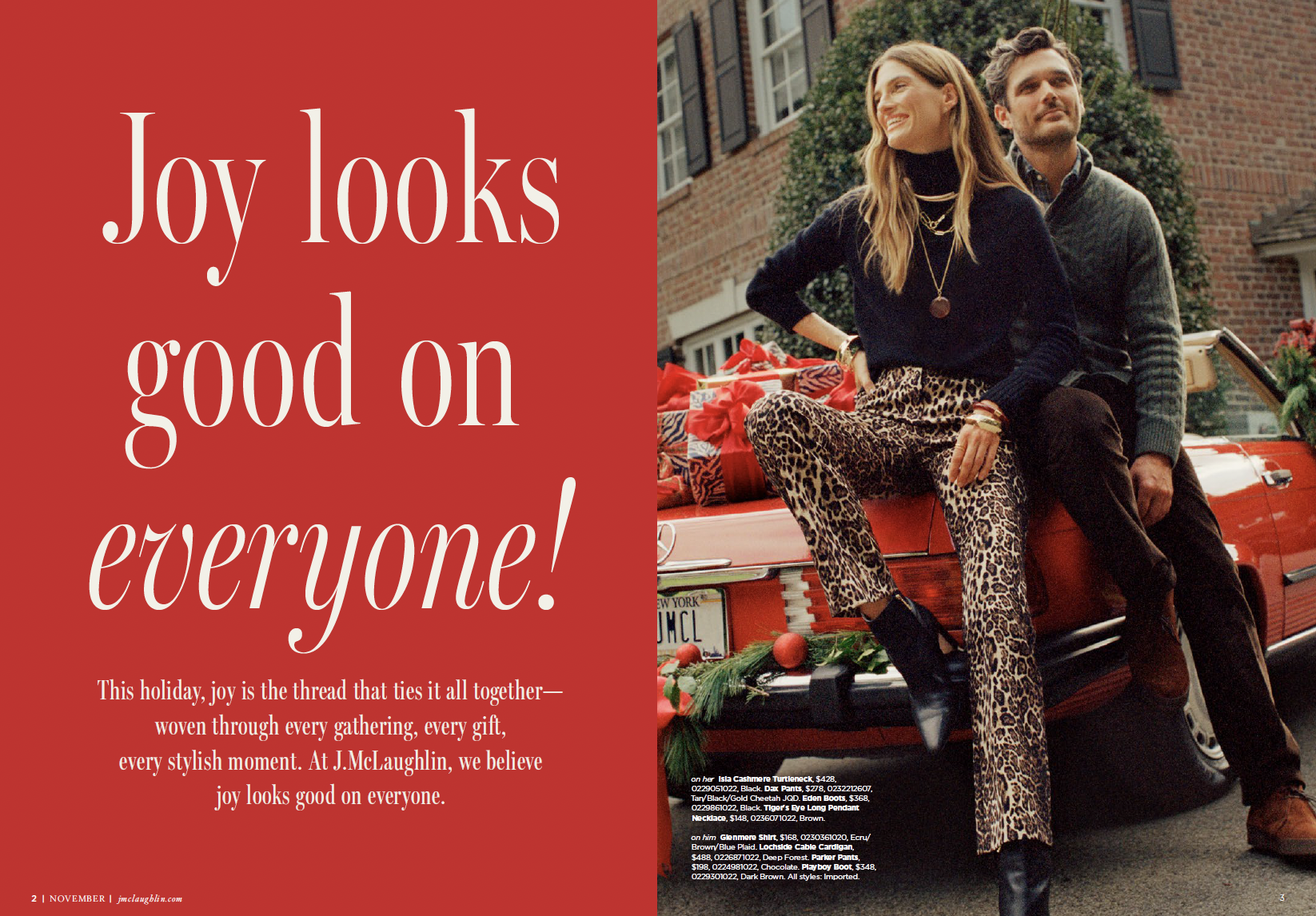 A woman and a man sitting on the trunk of a red convertible car decorated with holiday ornaments. The woman is wearing leopard print pants and a black top, and the man is in a gray sweater. They are smiling with a brick house and greenery in the back