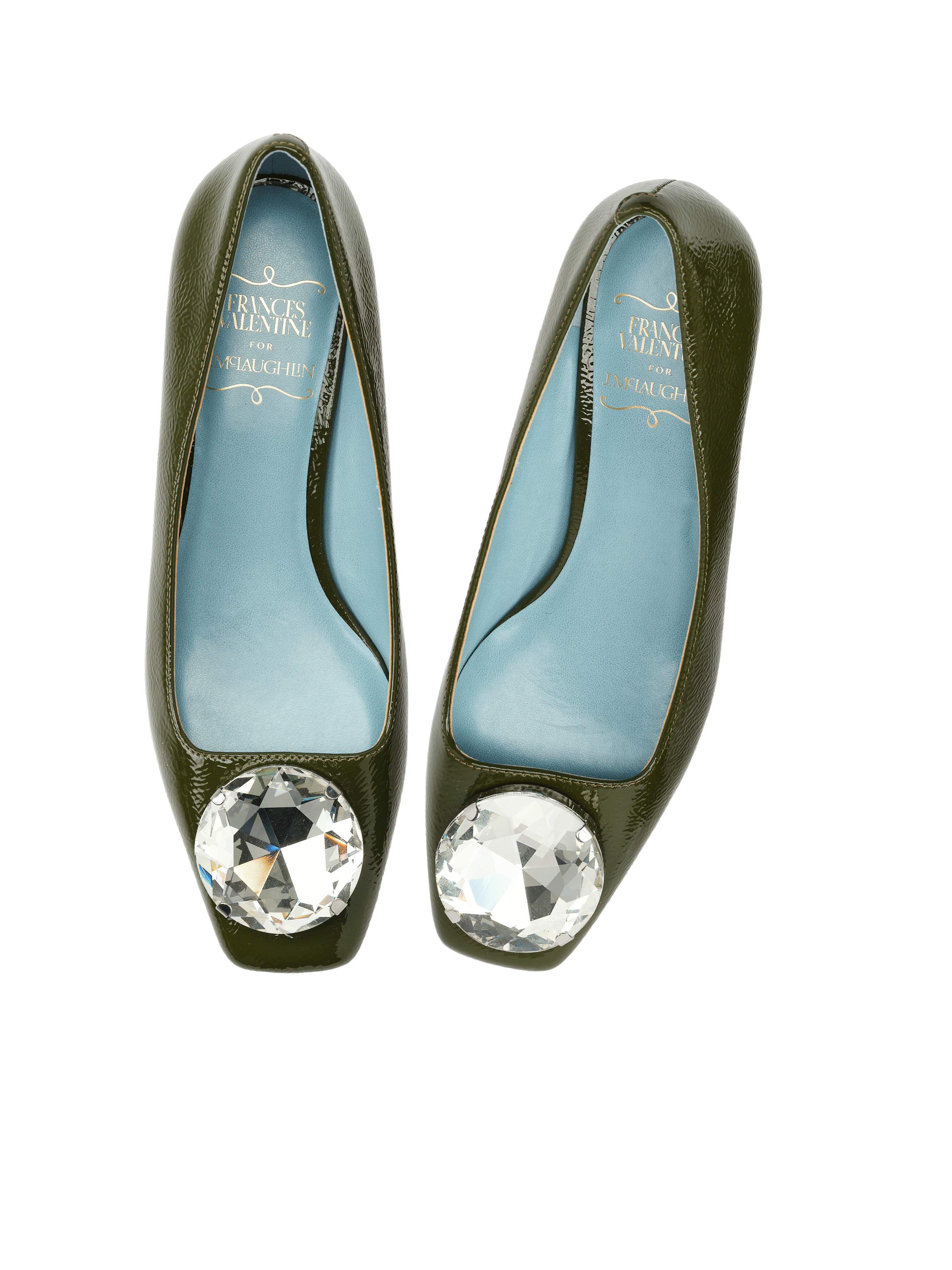 Pair of green patent leather high heels with large round diamond embellishments on the toe area, featuring blue insoles with gold text.