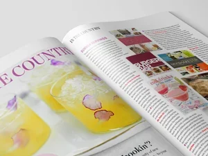 Open magazine with colorful images and text on pages.