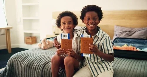 Passport 2 Boys sitting on a bed.jpg