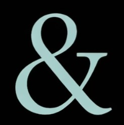 Close-up of a large, light blue ampersand symbol on a black background.