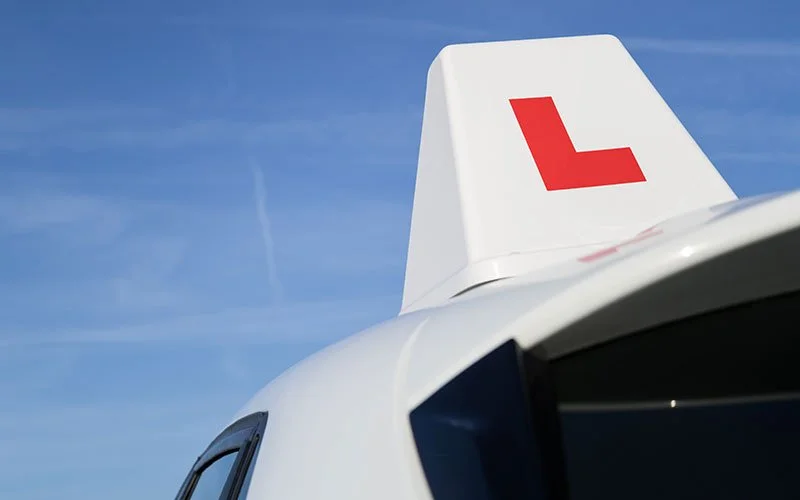 A car with a learner driver L