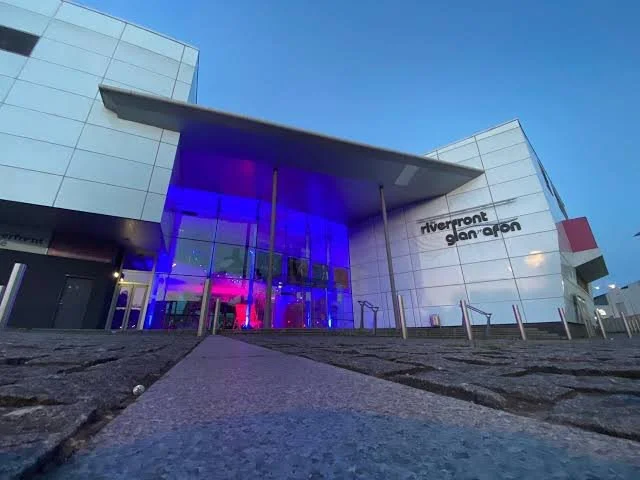 Photograph of the front entrance of the Riverfront Theatre in Newport. Image source: https://asiw.co.uk/news/newports-riverfront-re-opening