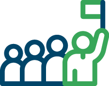 A person raising a hand in a group setting with three other individuals.