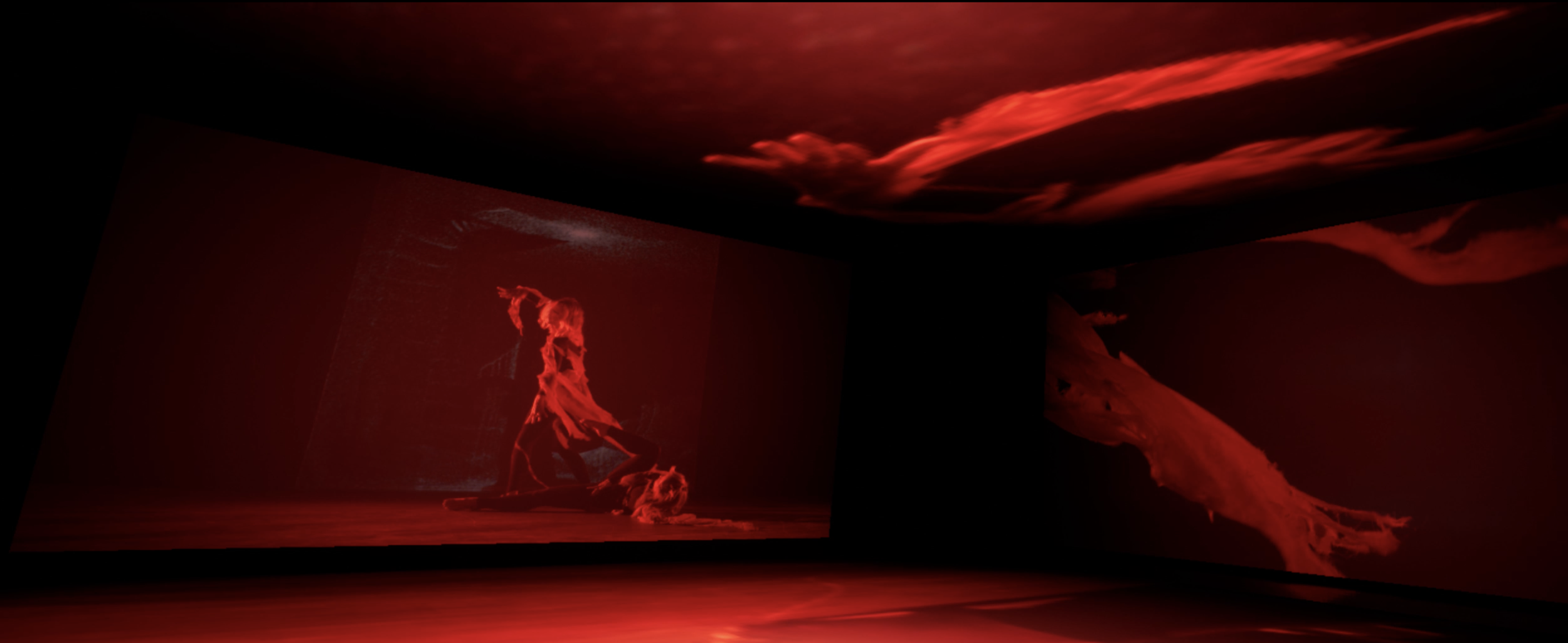 Dark room with red lighting, featuring a digital art projection of a human figure and abstract shapes on the walls and ceiling.
