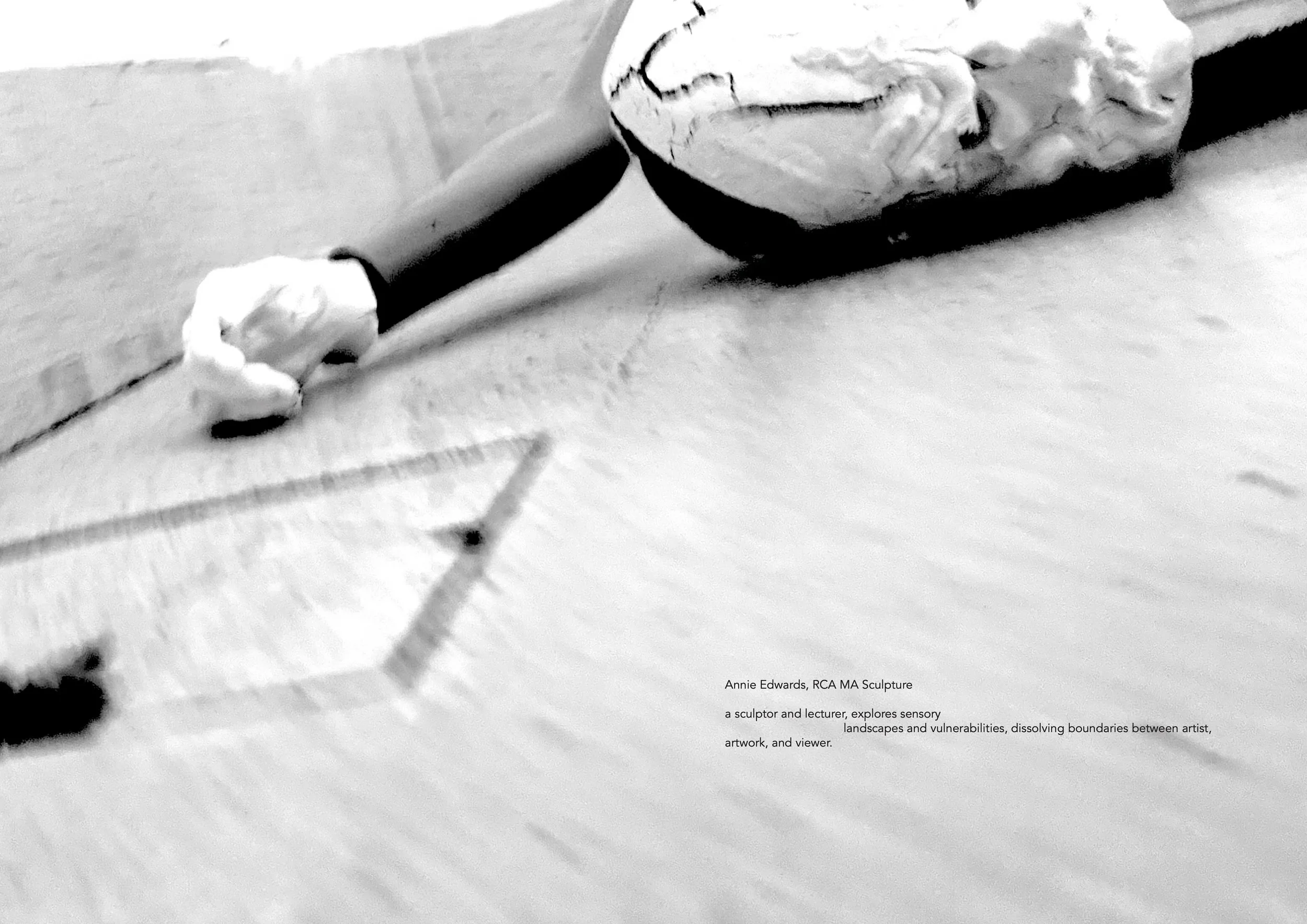 A black and white photograph showing a broken sphere with a textured surface, placed on a flat surface. There is a caption at the bottom right associating the scene with the work of Annie Edwards, RCA MA, exploring sensory landscapes and vulnerabilities.