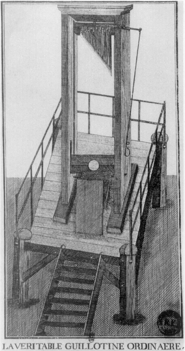 A black and white drawing of a guillotine with a tall wooden frame, a blade suspended at the top, a platform at the bottom, and a set of stairs leading up to it, labeled in Latin as 'LAVG VERITABLE GUILLOTINE ORDINAERE'.