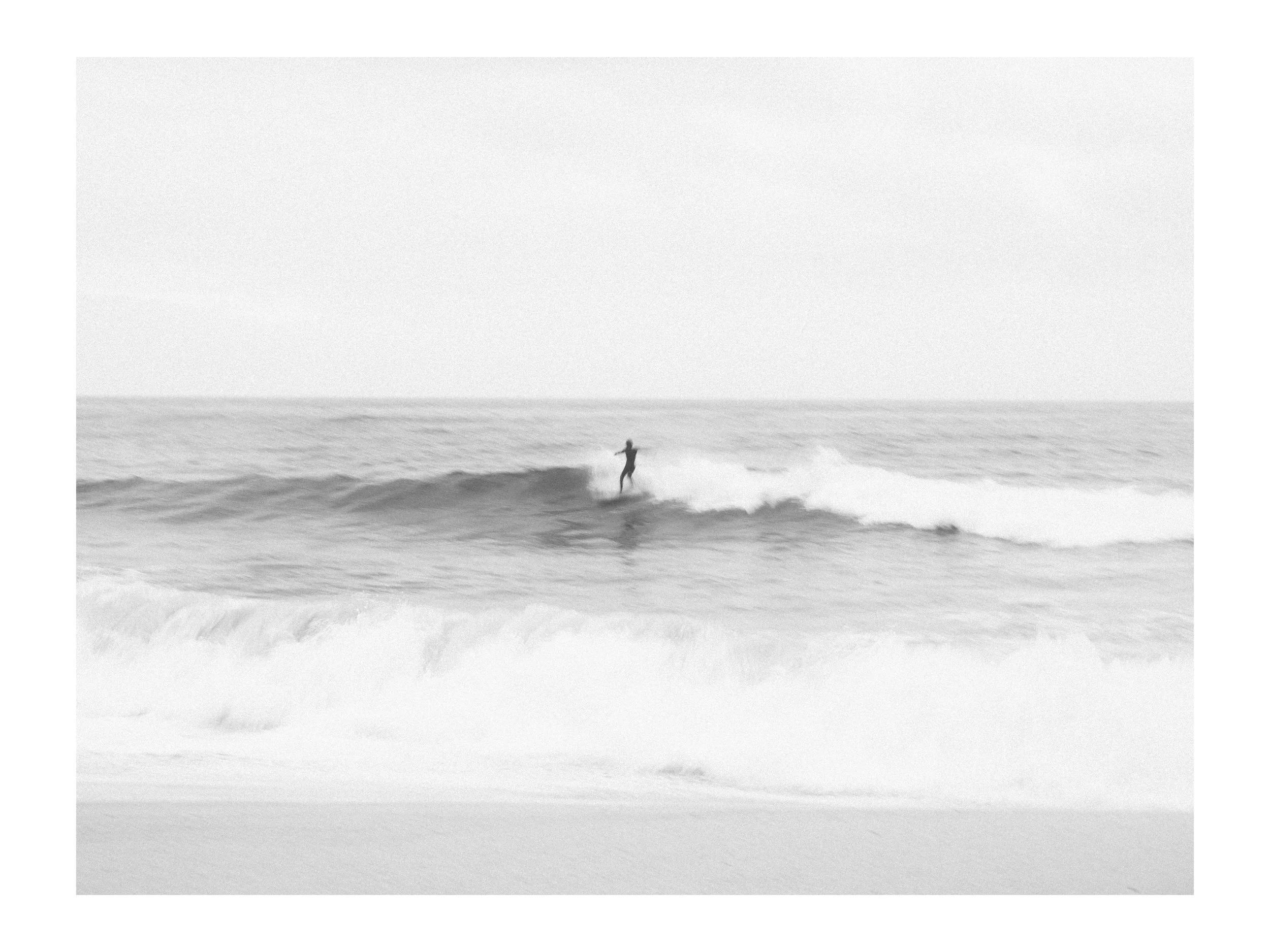 A person surfing on a wave in the ocean.