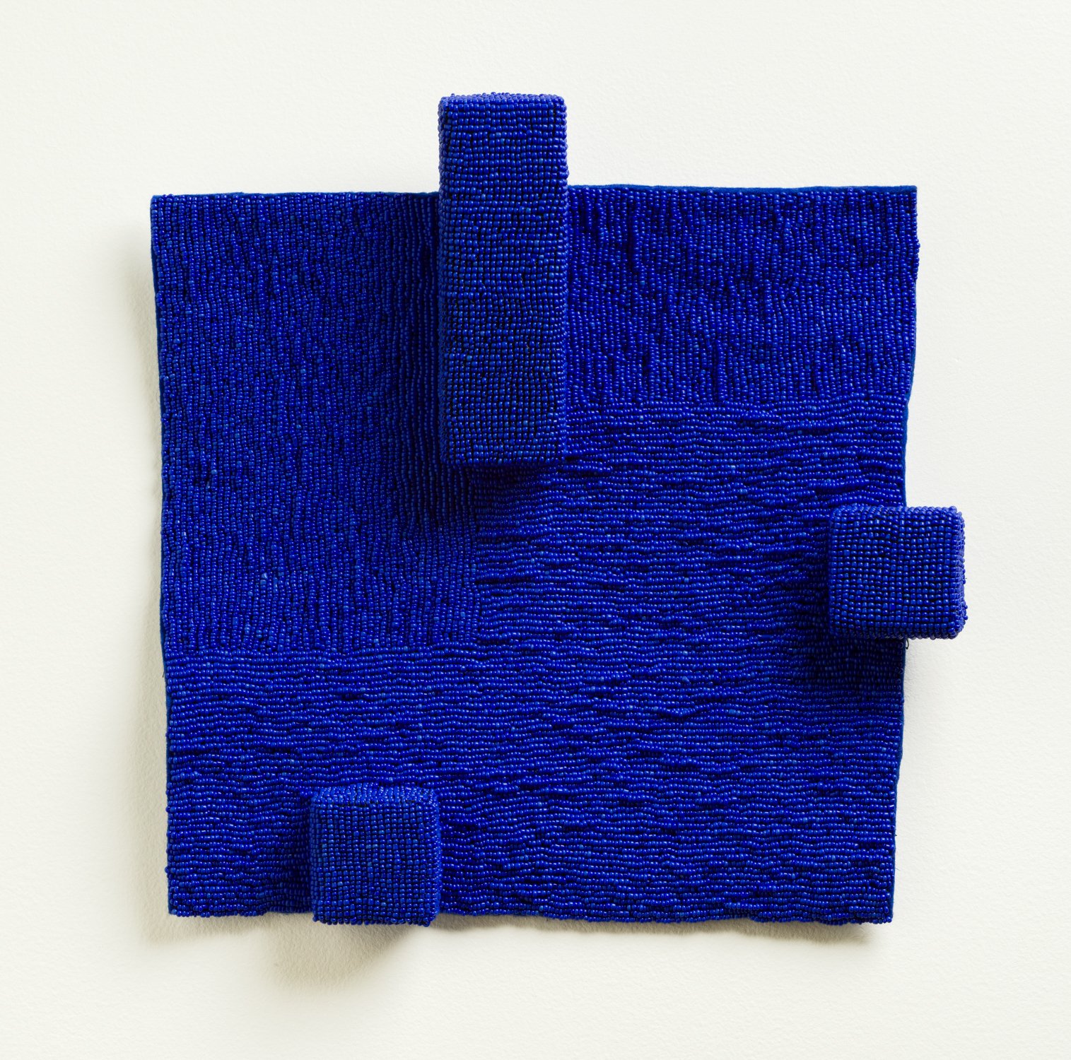 Eleanor Anderson “Felt 2” (12” x 13” x 1”) beads, industrial felt, wood blocks. 2,000.