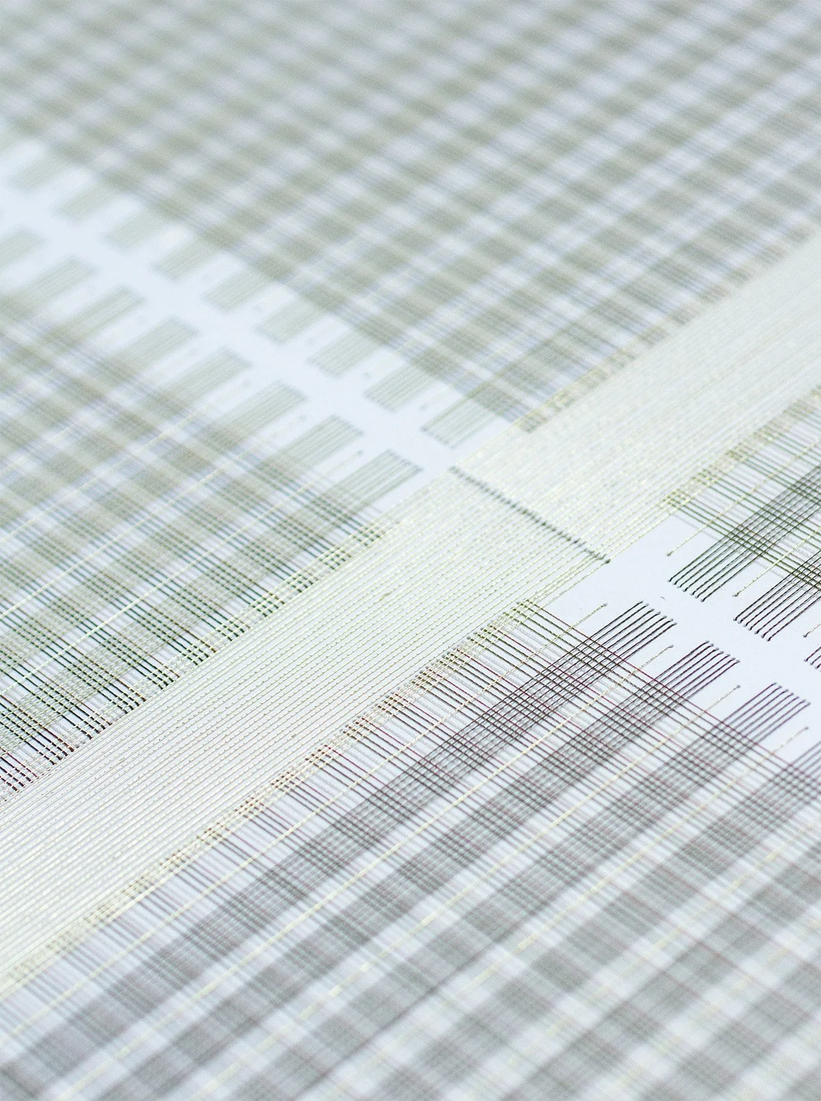 Detail of hand-stitched paper artwork showing textured thread patterns.