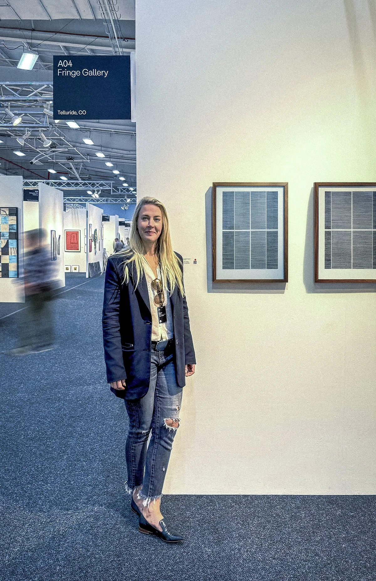 Rebecca Messier standing beside her art on display at the Art on Paper Art Show in New York City, 2026.