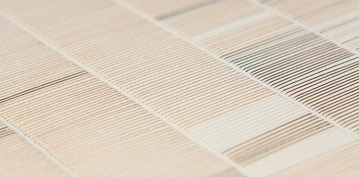 Detail of hand-stitched paper artwork showing textured thread patterns.