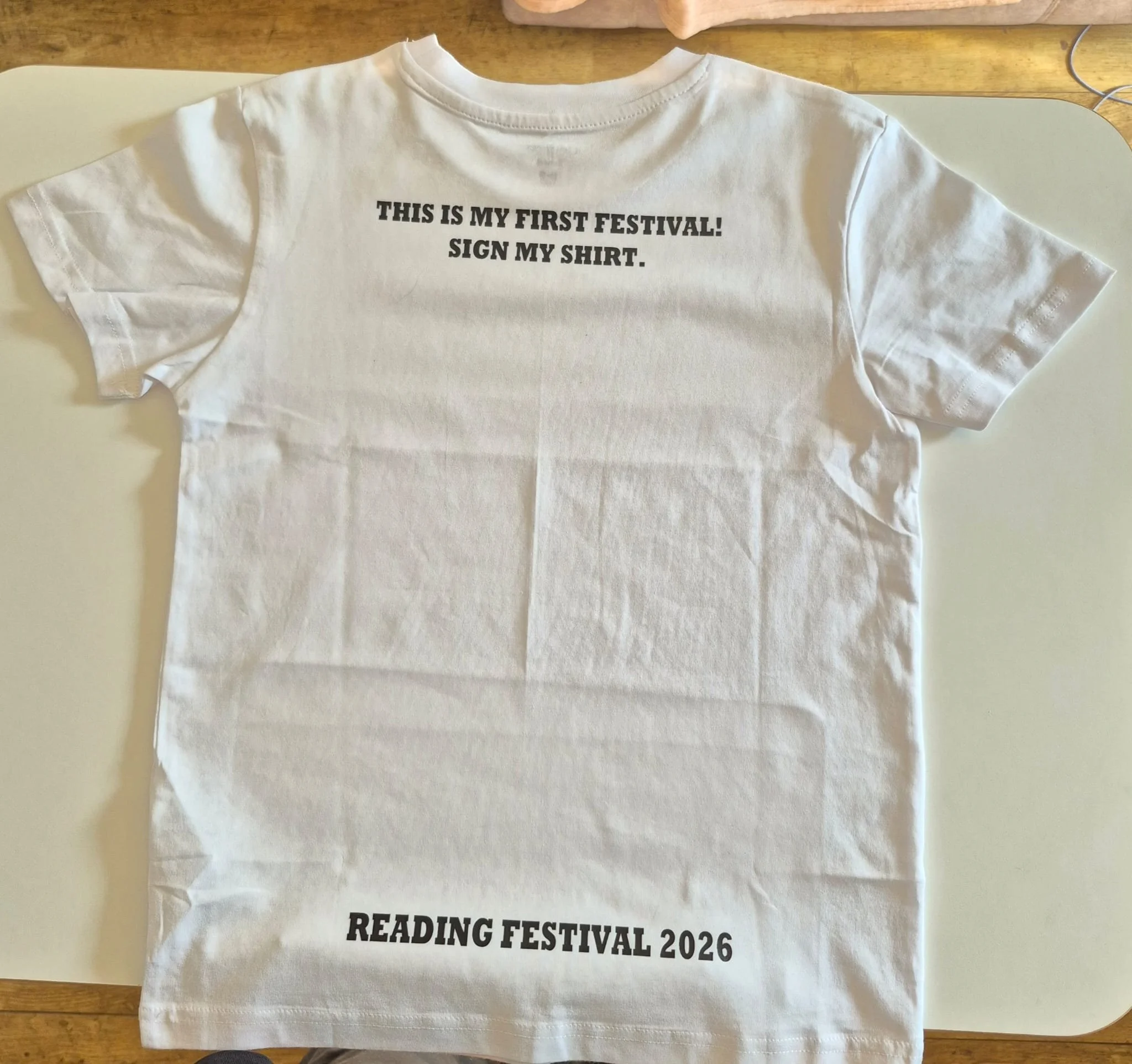white tshirt with writing This is my first festival sign my shirt