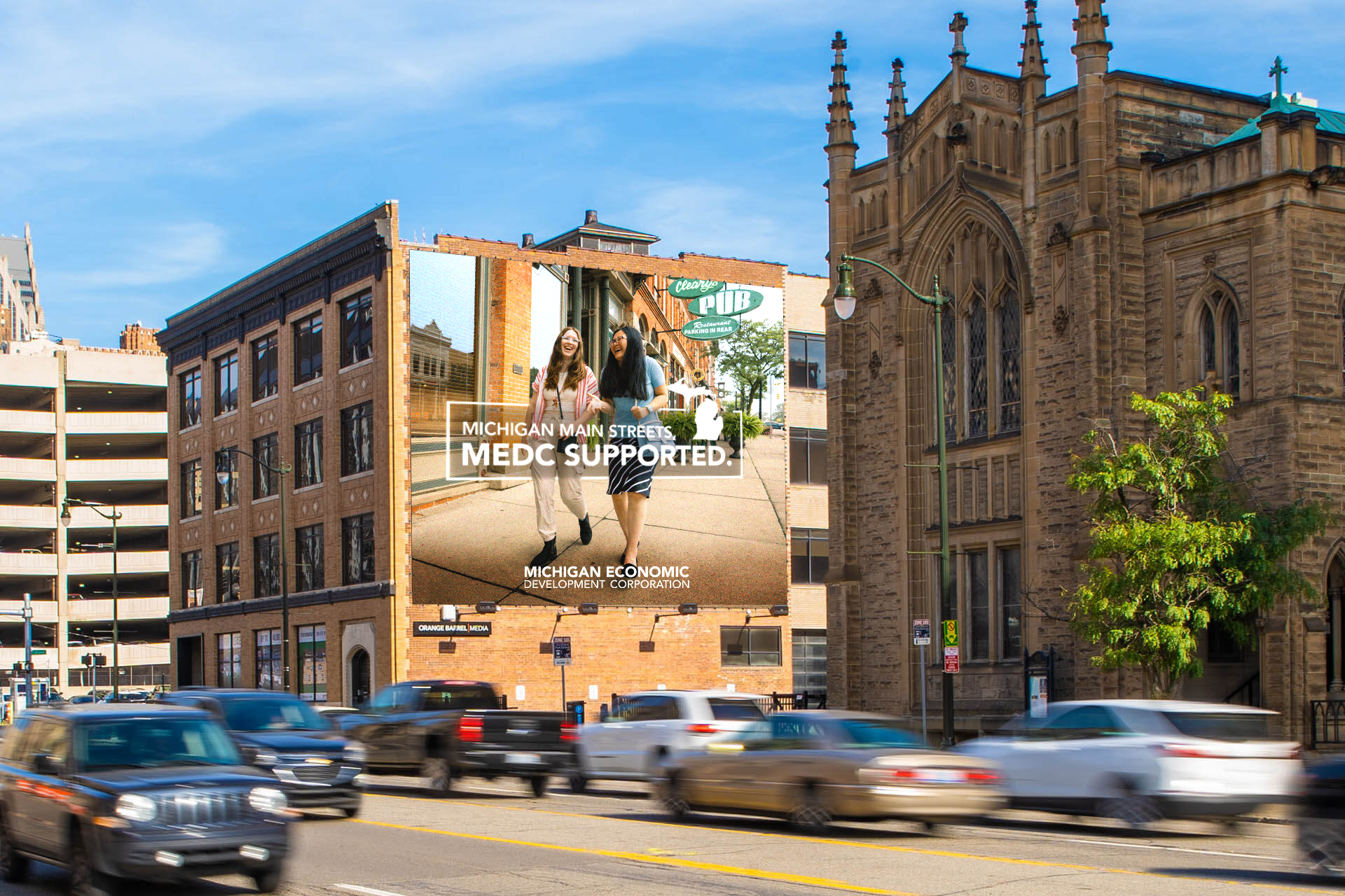 Large downtown billboard featuring a "Michigan Made, MEDC Supported" advertisement against a blue sky. Created by Detroit based Art Director and Designer Justin Scott.