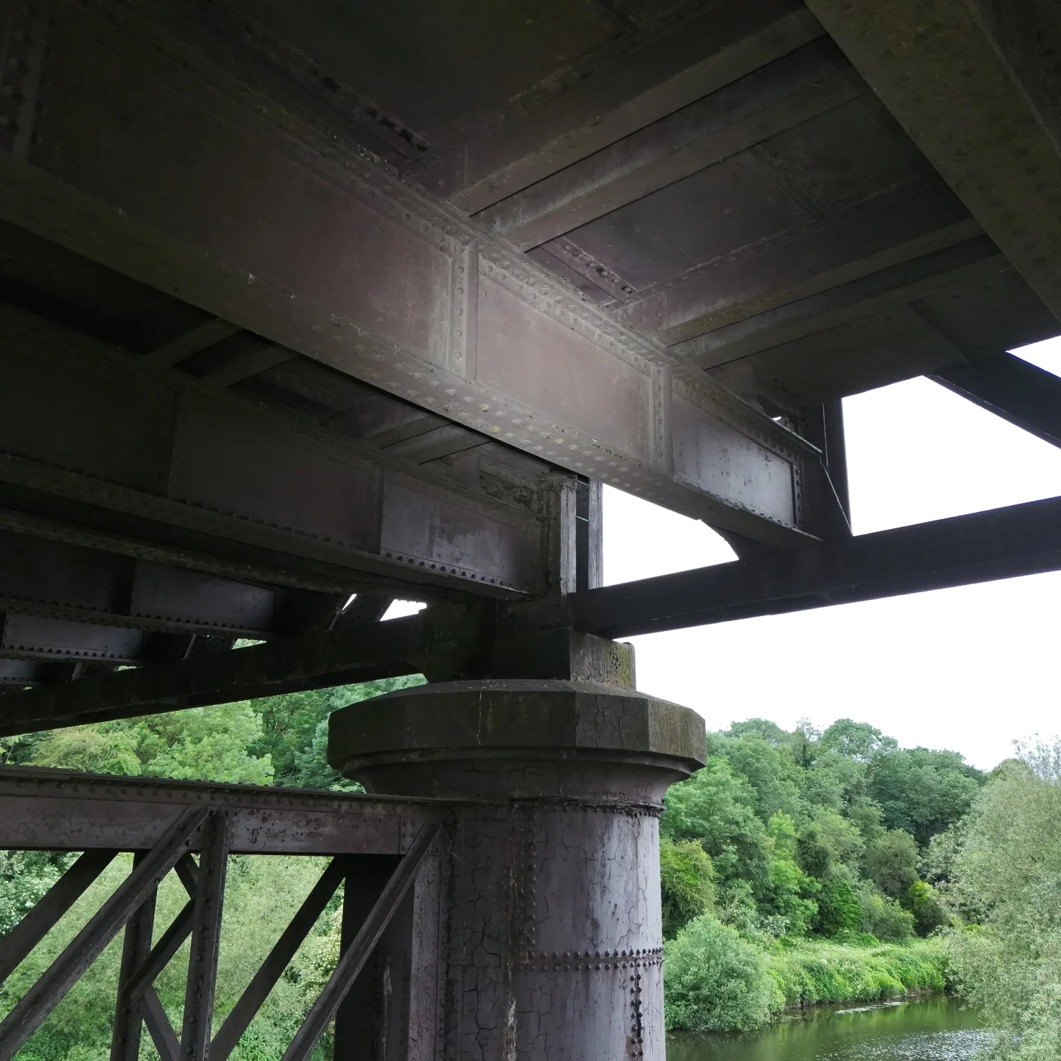 Aerial view of a bridge structure during a commercial asset management flight over a river.