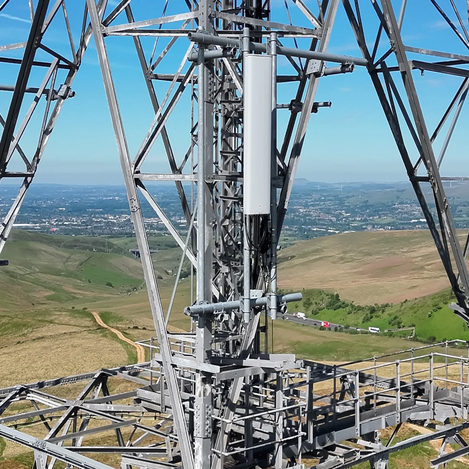 Wide drone asset inspection shot of a lattice telecom tower overlooking a rural landscape.

Gallery Caption: Comprehensive telecom tower drone inspection. This wide-angle asset management capture provides full structural context of the lattice tower 