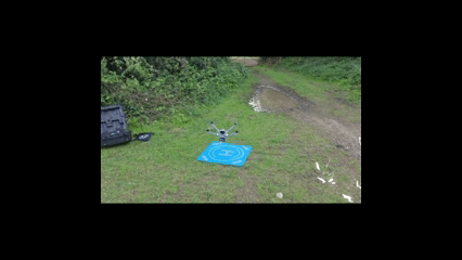 Professional drone inspection setup on a rural track in Yorkshire, showing a DJI enterprise drone on a blue landing pad with specialized equipment cases.