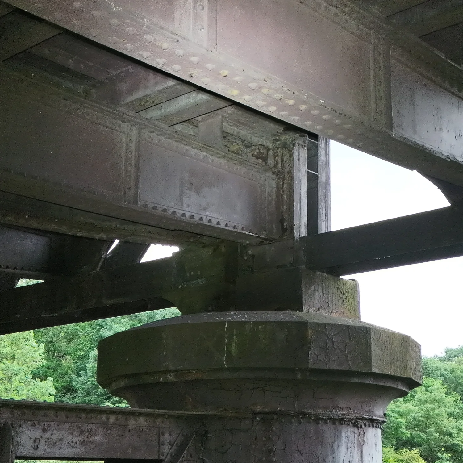 Under-bridge inspection view capturing steel support beams and structural connections.